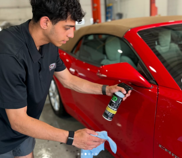 Forward Detailing technician wiping down vehicle